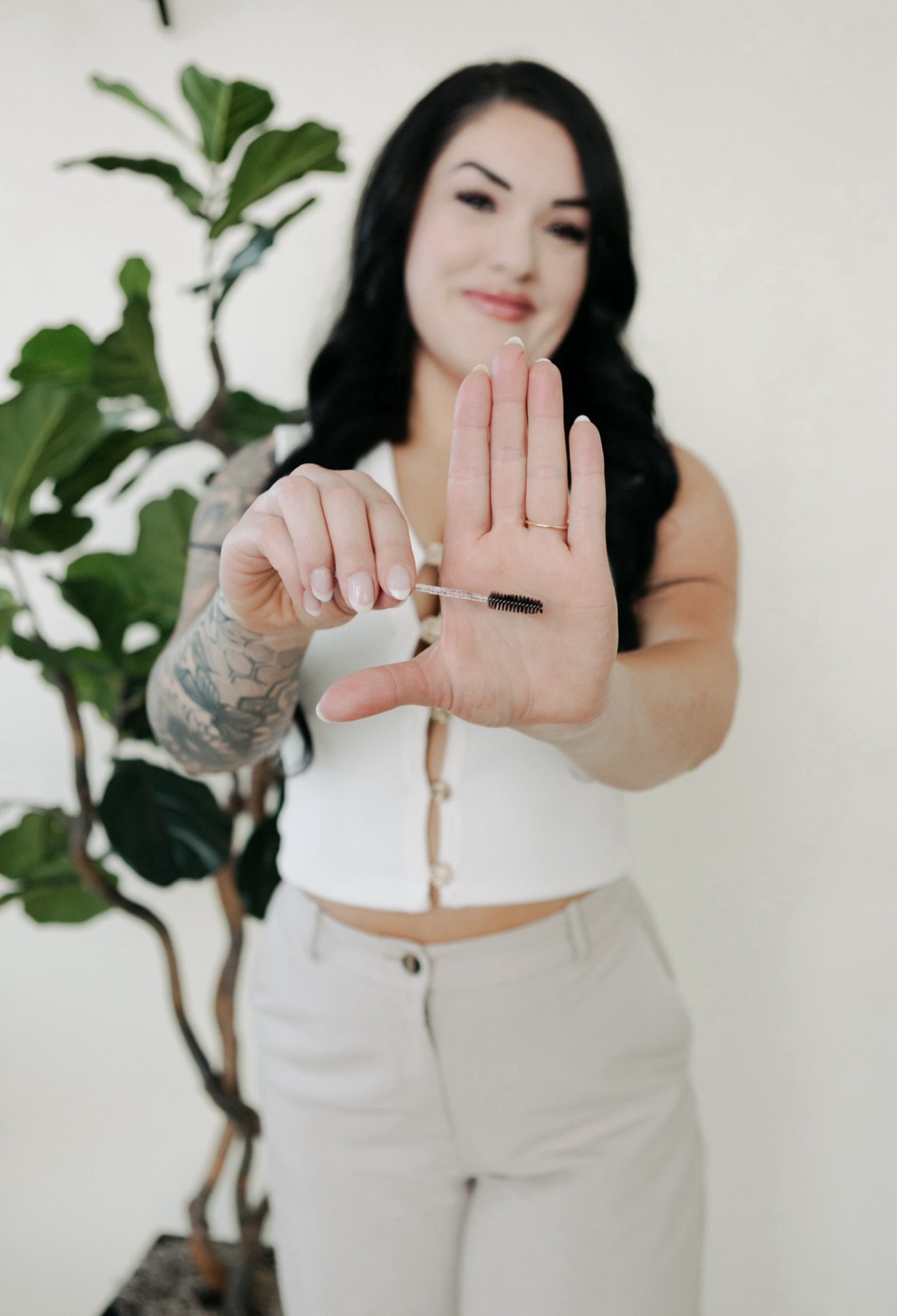 Jennifer holding a lash spoolie at Blink & Slay Beauty.